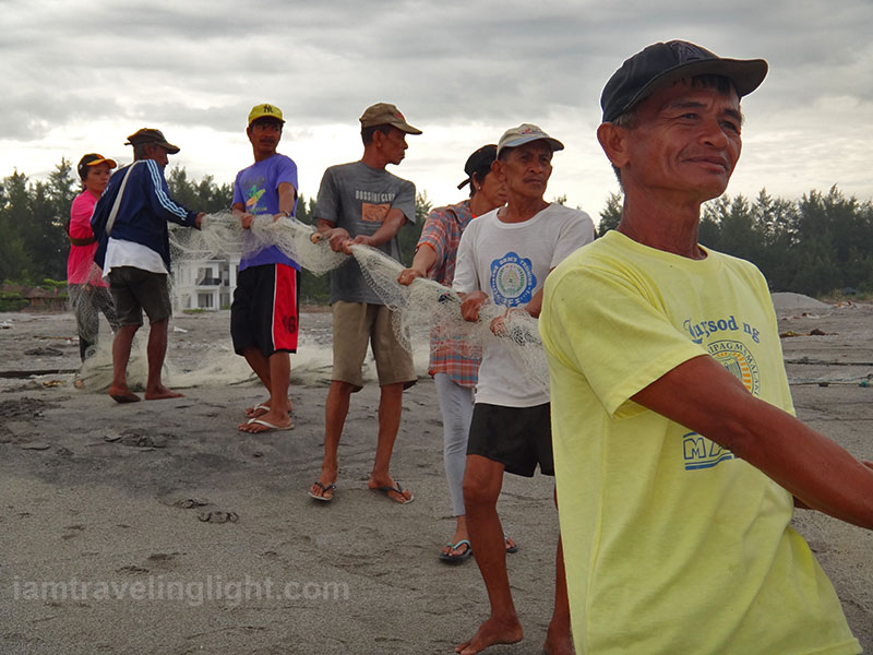 fisherfolk pulling net, catching fish, morning, surfing beach, mountain backdrop, surf, Liwliwa, San Felipe, Zambales